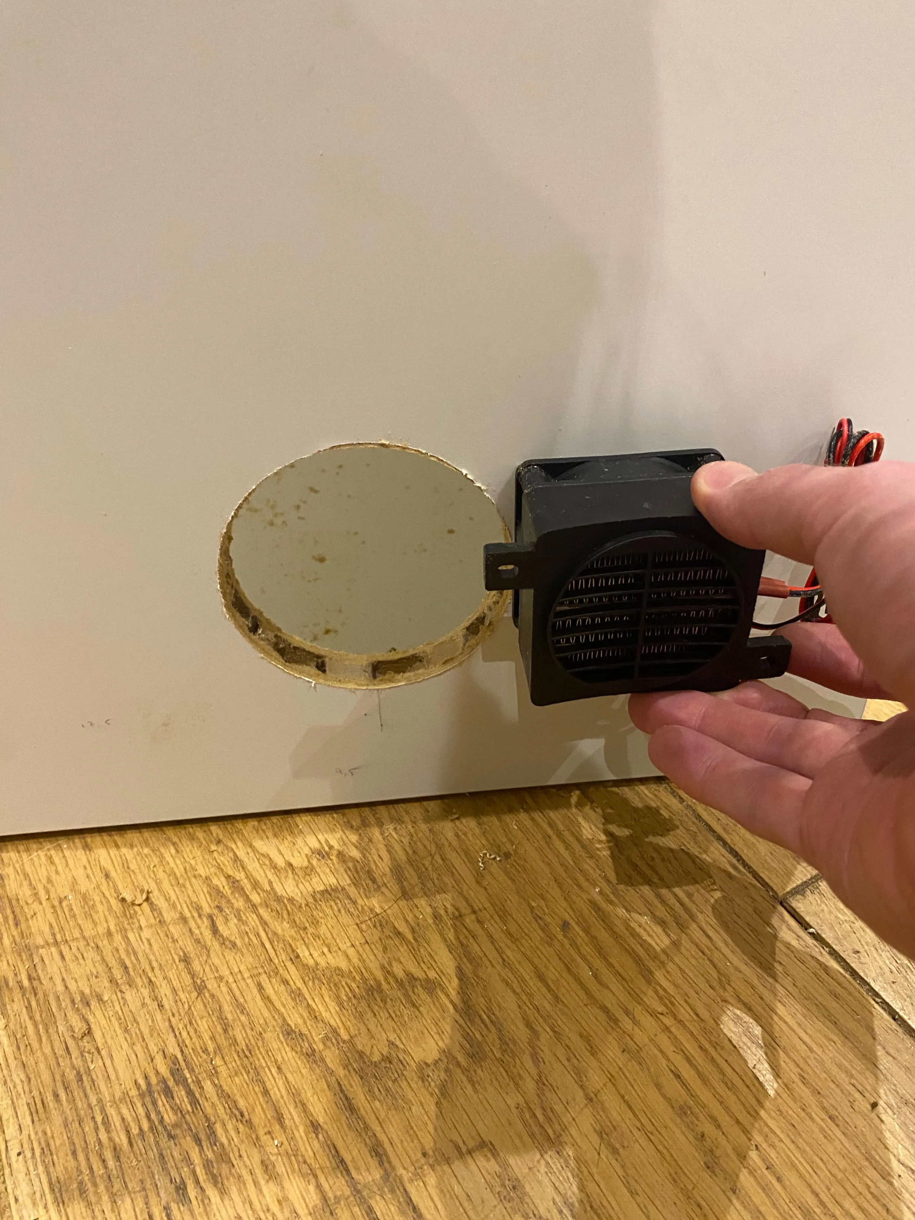 Offering the PTC heater up to the side wall aperture to check the fit